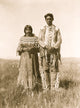Piegan man and woman standing in open prairie poster print