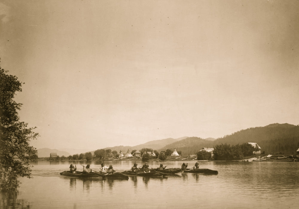 Canoes in water with mountains in the background - Poster Print