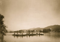 Canoes in water with mountains in the background - Poster Print