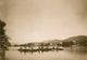 Canoes in water with mountains in the background - Poster Print