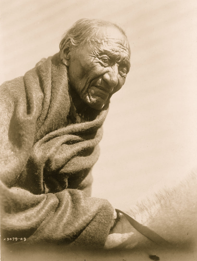 Elderly Piegan man portrait poster print, seated on horse, wrapped in blanket.