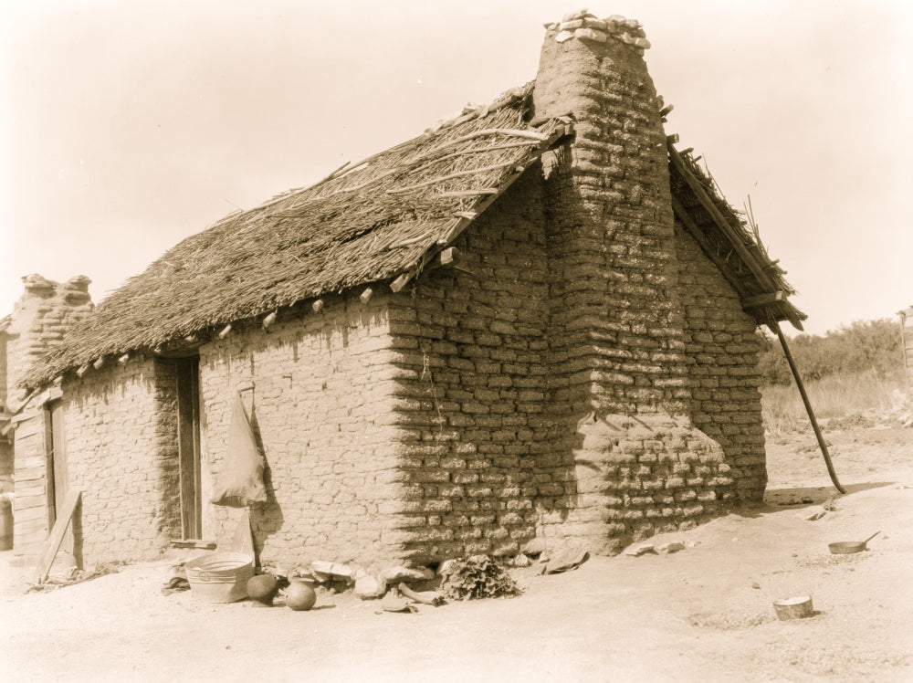Mud Brick & Thatch Home Poster Print showcasing rustic architecture.