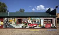 Danny's Gas Hole mural poster print featuring a Corvette, motorcycle, coke machine, and oil can.