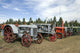 Old tractors along the road poster print showcasing rustic charm and Montana landscapes.