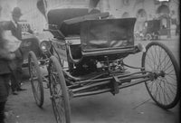 One of the First Automobiles Poster Print showcasing classic car art.
