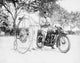 Policeman on a motorcycle giving a ticket to a man on a penny-farthing bicycle in Washington, DC