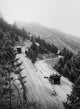 Mountain Road with Automobiles Poster Print showcasing a scenic landscape