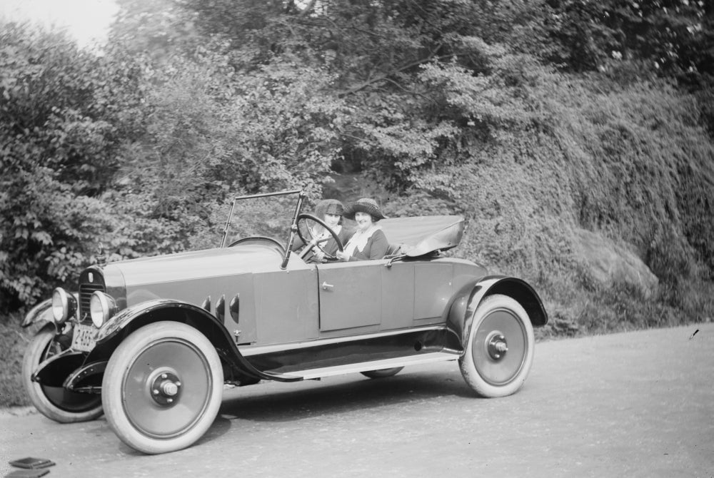 Two Women in a Coupe Poster Print showcasing vintage elegance.