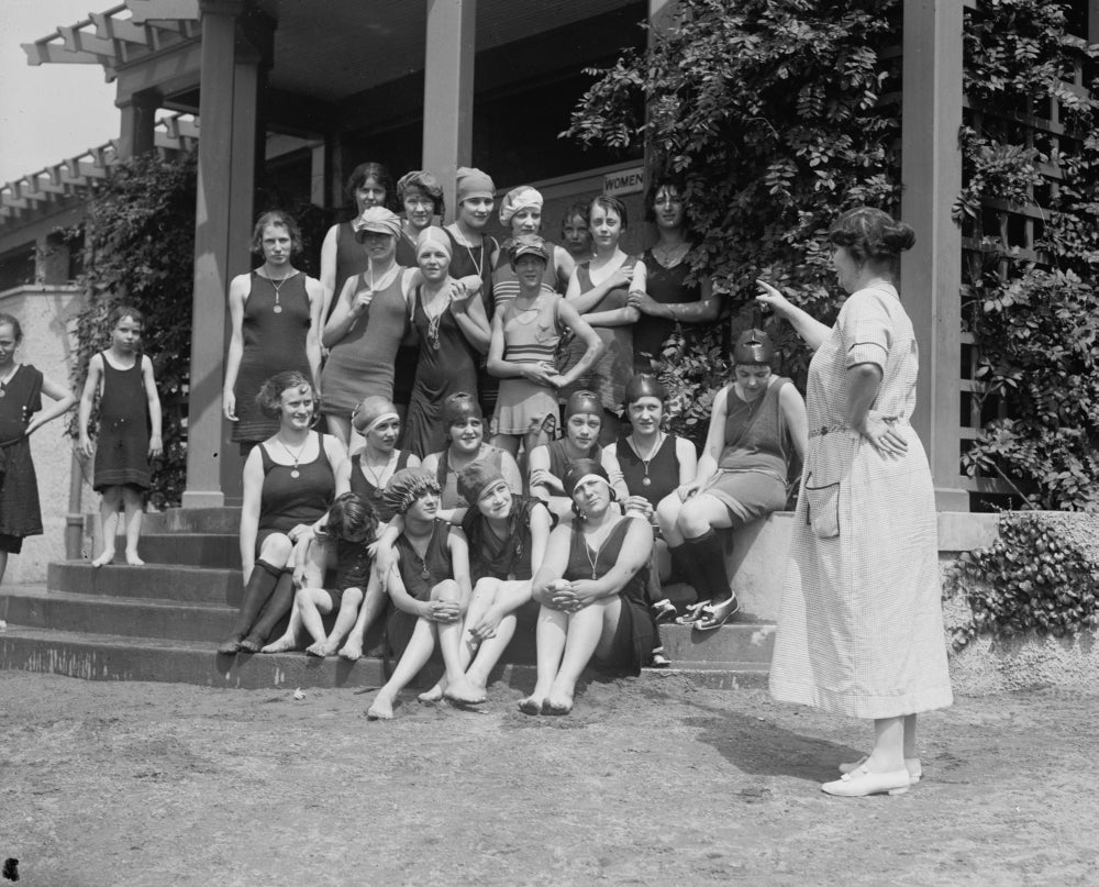 Matron points at young girls sitting on beach house steps poster print