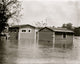 Floodwaters rise around a garage and home poster print