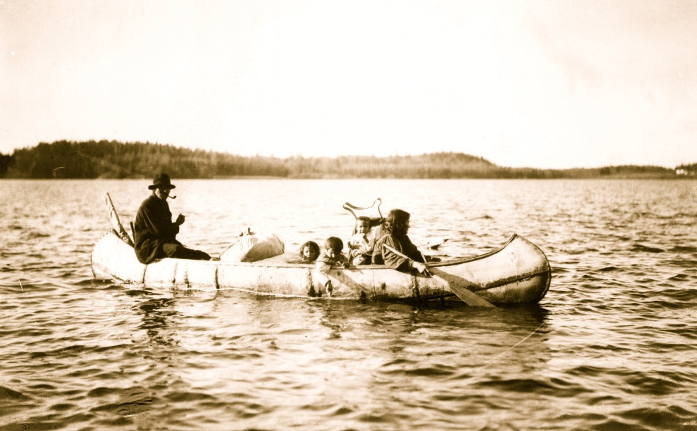 Five Ojibwa Indians Canoeing Poster Print featuring a man, woman, and three children.
