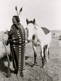 Sioux Indian full-length portrait poster print featuring a warrior holding a rifle in front of a horse.