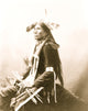 Good Eagle Indian Poster Print, three-quarter length, seated, holding bow and arrows.