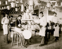 Young Native American men in a metalworking workshop surrounded by metal items.