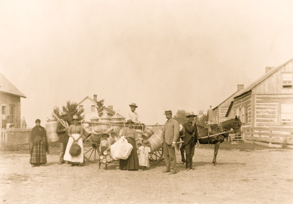 Group portrait of St. Regis Mohawk men and women with baskets.