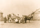 Group portrait of St. Regis Mohawk men and women with baskets.