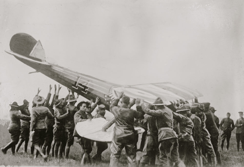 Righting an Overturned Plane Poster Print capturing the moment of a plane being righted.
