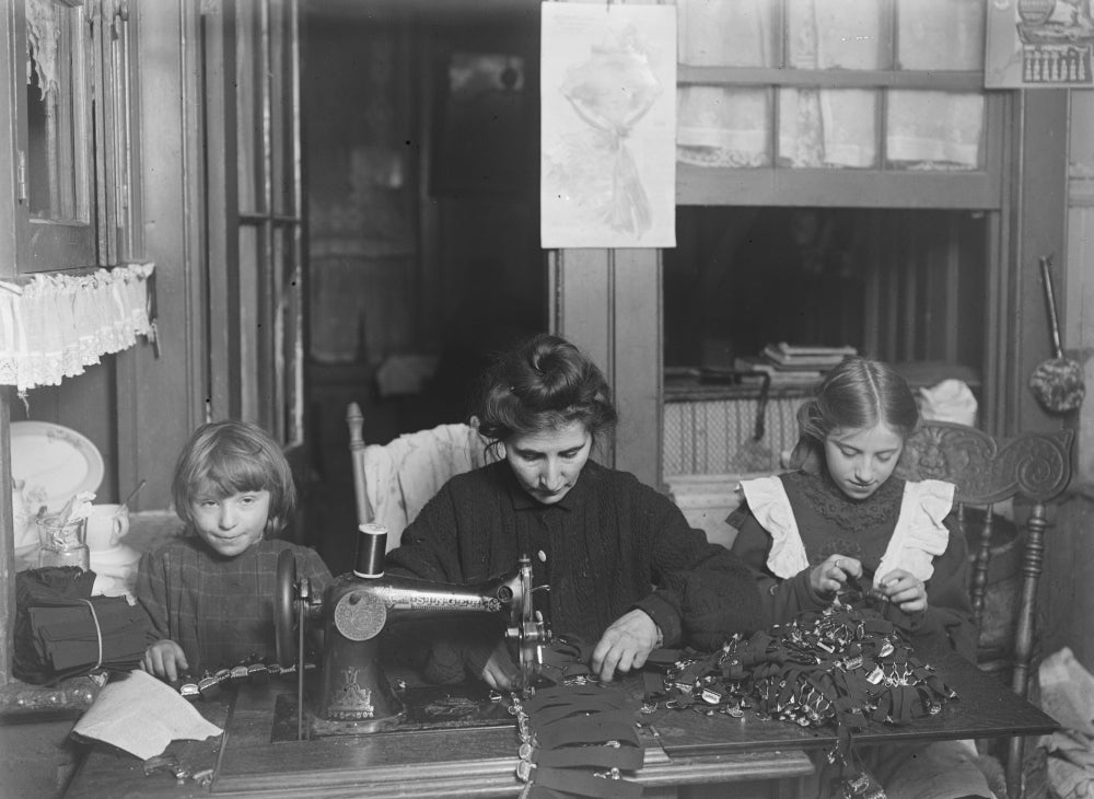 Vintage poster print of Mrs. Finkelstein with daughters making garters.