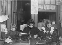 Vintage poster print of Mrs. Finkelstein with daughters making garters.