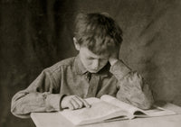 A Boy Reads a Book Poster Print
