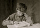 A Boy Reads a Book Poster Print