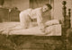 A Young Boy Climbs into Bed Poster Print - Cozy Childhood Art