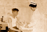 Nurse at Cheney Silk Mills bandages a boy's arm poster print