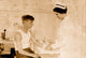 Nurse at Cheney Silk Mills bandages a boy's arm poster print