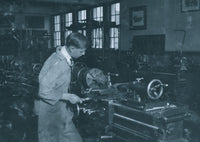 High school student working in a machine shop poster print.