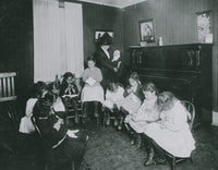Sewing Class at Sprague House Settlement Poster Print showing a director holding a deserted baby.