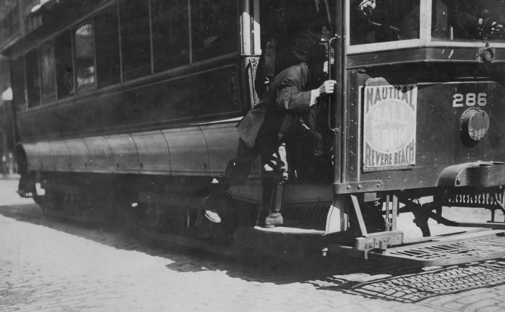 Schoolboy Jumps on Trolley Poster Print showcasing a playful scene.