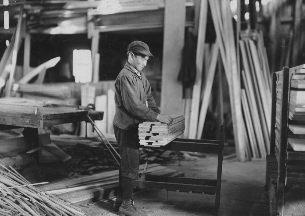 Boy tying strips from planer at Schultze Waltum Co. Planing Mill poster print