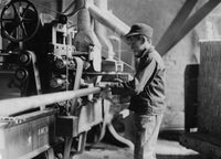 Boy taking boards away from double cut-off machine poster print