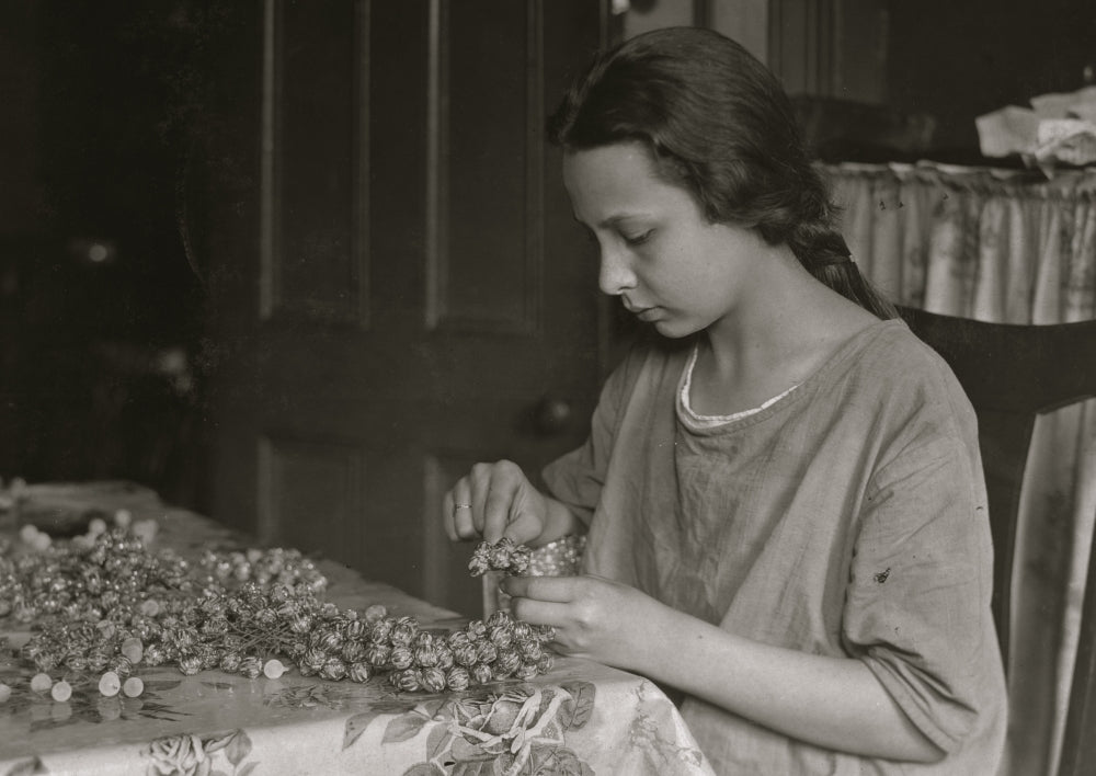 Cottage Industry Poster Print showcasing a young girl stringing material.