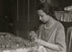 Cottage Industry Poster Print showcasing a young girl stringing material.