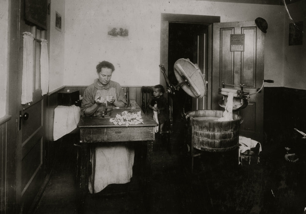 Mrs. Eugene Lampron putting bristles into toothbrushes in her kitchen - Poster Print