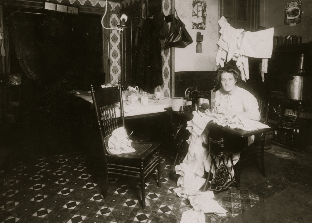 Annie Maier Working in the Kitchen Poster Print showcasing a woman crafting pinafores.
