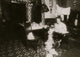 Annie Maier Working in the Kitchen Poster Print showcasing a woman crafting pinafores.