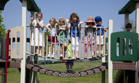 Children playing on a playground at Rise School in Tuscaloosa, Alabama poster print.