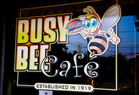 Busy Bee Cafe Poster Print showcasing a lively café scene.