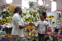 African American Mother Giving Child a Flower Poster Print