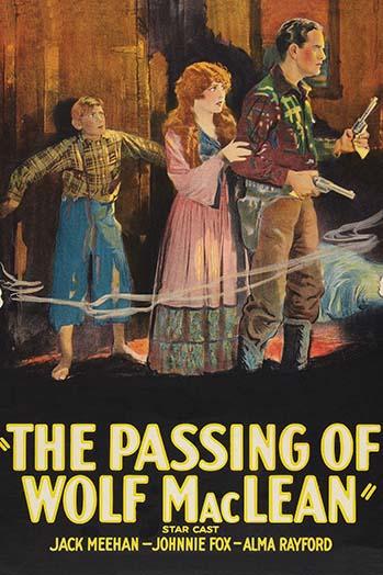 Cowboy holding two pistols with a redhead and a young boy against a wall.