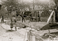 African American man drilling a well with a horse on a turnstile poster print