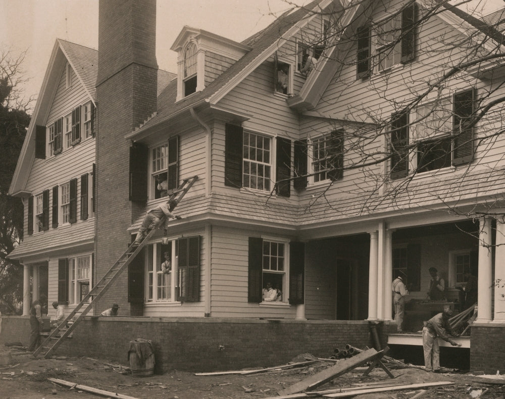 Students at work on a house built largely by them poster print.