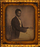 Three-quarter length portrait of James B. Yates seated at desk.