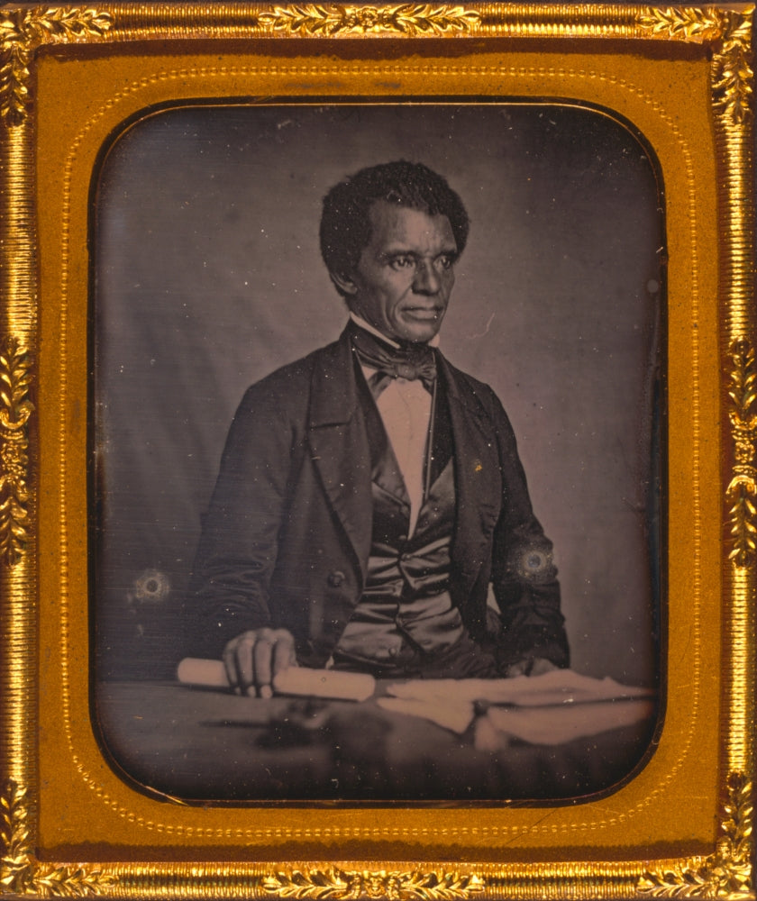 Beverly Page Yates half-length portrait print, seated at table holding paper.