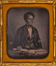 Beverly Page Yates half-length portrait print, seated at table holding paper.