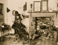 African American man shaving another in a warm, intimate moment poster print.