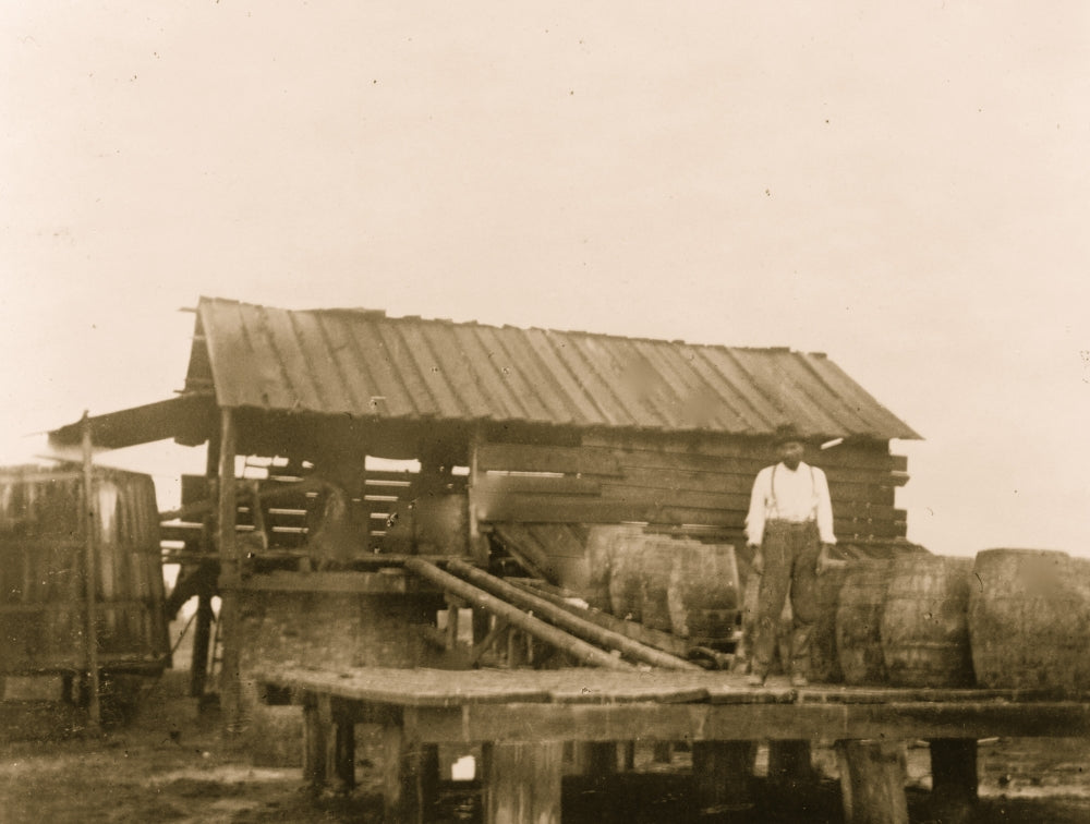 African American man standing on platform with barrels in Georgia poster print.