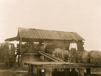African American man standing on platform with barrels in Georgia poster print.